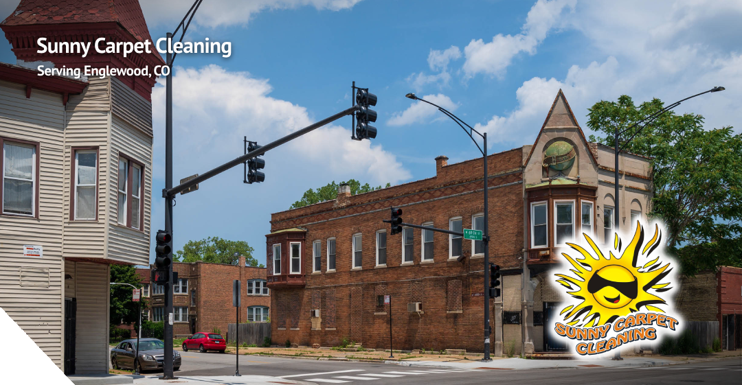 Sunny Carpet Cleaning logo and text overlay on a street view of Englewood, CO, showcasing urban architecture and traffic signals, emphasizing local carpet cleaning services.